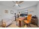 Office featuring wood-look tile floors, natural light, a desk, and an office chair at 4396 Pasadena Cir, Sarasota, FL 34233