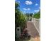 Pathway leading to a lake with wood fencing and lush foliage on a bright sunny day at 4396 Pasadena Cir, Sarasota, FL 34233