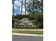 Stone sign at The Reserve at Crossing Creek with lush landscaping and tropical foliage surrounding it at 4407 67Th E St, Bradenton, FL 34203
