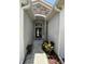 Close up of the front door with brick pavers, stacked stone and dark wood door with transom window at 4407 67Th E St, Bradenton, FL 34203