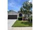 Well maintained single Gathering home with manicured lawn and a large shade tree in the front yard at 4407 67Th E St, Bradenton, FL 34203