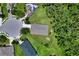 A bird's eye view showcases the house, highlighting its well-maintained lawn and proximity to trees at 4716 98Th E Ter, Parrish, FL 34219