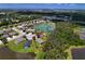 Aerial view of property showcasing its location near a pond and surrounded by lush greenery at 4716 98Th E Ter, Parrish, FL 34219
