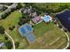 Aerial view of the community clubhouse, pool, tennis courts, and open green spaces at 4716 98Th E Ter, Parrish, FL 34219