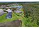 Aerial shot showcasing a home with screened pool overlooking a serene lake and a well-maintained yard at 4716 98Th E Ter, Parrish, FL 34219