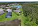 Aerial shot showcasing a home with screened pool overlooking a serene lake and a well-maintained yard at 4716 98Th E Ter, Parrish, FL 34219