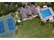 Aerial view of neighborhood amenities including a pool, tennis courts, playground, and clubhouse at 4716 98Th E Ter, Parrish, FL 34219