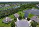 A bird's-eye view of the house, emphasizing the surrounding green spaces and proximity to community features at 4716 98Th E Ter, Parrish, FL 34219