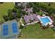 Aerial view of community center featuring a pool, tennis courts, playground, and manicured grounds at 4716 98Th E Ter, Parrish, FL 34219