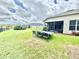 View of the home's exterior and backyard, featuring a patio and landscaping at 4716 98Th E Ter, Parrish, FL 34219