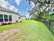 Large, well-maintained backyard featuring green grass, landscaping, and a privacy fence at 4716 98Th E Ter, Parrish, FL 34219