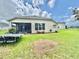 View of the home's exterior and backyard, featuring a patio and landscaping at 4716 98Th E Ter, Parrish, FL 34219