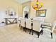 Dining room showcasing stylish decor, lighting fixture, and adjacent archway to the kitchen at 4716 98Th E Ter, Parrish, FL 34219