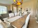 Dining room with a large wood table, seating for ten, and view of front door at 4716 98Th E Ter, Parrish, FL 34219