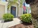 Close-up of a front door with a decorative wreath, well-manicured bushes, and a tidy walkway at 4716 98Th E Ter, Parrish, FL 34219