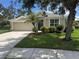 Charming single-story home with a well-kept lawn, landscaping, a two-car garage, and a welcoming entryway at 4716 98Th E Ter, Parrish, FL 34219