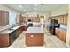 Spacious kitchen featuring a large island, stainless appliances, and wooden cabinetry at 4716 98Th E Ter, Parrish, FL 34219