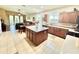 Open kitchen featuring a center island, wood cabinetry, and view into the living area at 4716 98Th E Ter, Parrish, FL 34219