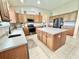 Spacious kitchen with an island, stainless steel appliances, and ample cabinet space at 4716 98Th E Ter, Parrish, FL 34219
