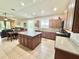Open kitchen with an island, dark wood cabinets, and view of living room and dining area at 4716 98Th E Ter, Parrish, FL 34219