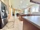 Open kitchen with stainless steel appliances, center island, and view of living room at 4716 98Th E Ter, Parrish, FL 34219