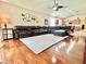 Comfortable living room with a large sectional couch, wood floors, and an open floor plan to the kitchen at 4716 98Th E Ter, Parrish, FL 34219