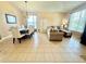 Open-concept living room with tile flooring and a dining area with a decorative chandelier at 4716 98Th E Ter, Parrish, FL 34219