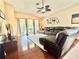 Bright living room with a sectional sofa, wood flooring, and access to the outdoor patio at 4716 98Th E Ter, Parrish, FL 34219