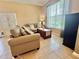 Comfortable living room with a sofa, side chair, side table and a large window for natural light at 4716 98Th E Ter, Parrish, FL 34219
