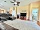Spacious living room with a leather sectional sofa, wood flooring, and easy access to a bedroom at 4716 98Th E Ter, Parrish, FL 34219
