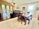 Inviting living room featuring a large leather sectional, wood-style floors and an adjacent dining area at 4716 98Th E Ter, Parrish, FL 34219