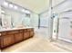 Spacious bathroom featuring a dual sink vanity, soaking tub, walk-in shower, and tile floors at 4716 98Th E Ter, Parrish, FL 34219