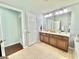 Spacious bathroom featuring a dual sink vanity, tile floors, and access to the bedroom at 4716 98Th E Ter, Parrish, FL 34219