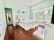 Well-lit main bedroom with wood floors, a large window, and a decorative white-themed interior at 4716 98Th E Ter, Parrish, FL 34219