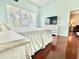 Inviting main bedroom with wood floors, natural light, and a white color scheme at 4716 98Th E Ter, Parrish, FL 34219