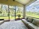 Relaxing screened-in patio featuring comfortable seating and views of the beautifully landscaped backyard at 4716 98Th E Ter, Parrish, FL 34219