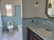 Bathroom with blue tile and marble-look floors, toilet, sink, and vanity at 5124 17Th Street E Ct, Bradenton, FL 34203