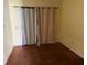 Bedroom with sliding glass doors to the backyard, featuring hard wood floors at 5124 17Th Street E Ct, Bradenton, FL 34203