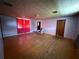 Living room featuring pink walls, wood-look floors, and a retro ceiling pattern at 5124 17Th Street E Ct, Bradenton, FL 34203