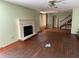 Living room with decorative fireplace, wood floors, and stairs in the background at 5124 17Th Street E Ct, Bradenton, FL 34203