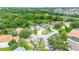Overhead view of a lovely home with backyard pool and surrounding neighborhood with lush greenery and nearby pond at 5139 50Th W Ave, Bradenton, FL 34210