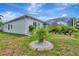A lush backyard featuring tropical landscaping, a screened-in lanai, and a well-maintained lawn creates a relaxing outdoor oasis at 5139 50Th W Ave, Bradenton, FL 34210