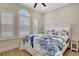 Bright bedroom featuring a ceiling fan, wood floors, and windows with white shutters at 5139 50Th W Ave, Bradenton, FL 34210
