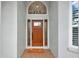 Elegant wood front door with sidelights and transom window, creating a grand entrance at 5139 50Th W Ave, Bradenton, FL 34210