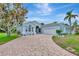 Charming single-story home with well-manicured lawn, stone-paved driveway, and lush tropical landscaping at 5139 50Th W Ave, Bradenton, FL 34210