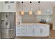Spacious kitchen featuring modern appliances, a large island, and stylish pendant lighting at 5139 50Th W Ave, Bradenton, FL 34210