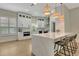Modern kitchen features white cabinets, stainless steel appliances, and a large island with seating for four at 5139 50Th W Ave, Bradenton, FL 34210
