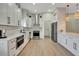 Well-lit kitchen boasts sleek white cabinets, stainless steel appliances, and an island with barstool seating at 5139 50Th W Ave, Bradenton, FL 34210
