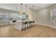 Spacious kitchen with white cabinetry, a center island with seating, and modern pendant lighting at 5139 50Th W Ave, Bradenton, FL 34210