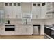 Modern kitchen with stainless steel appliances, sleek white cabinetry, and quartz countertops at 5139 50Th W Ave, Bradenton, FL 34210